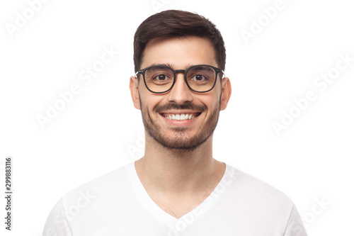 Smiling handsome young man in casual t-shirt, looking at camera, isolated on white background © Damir Khabirov