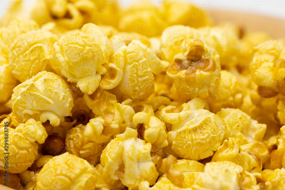 Butter caramel popcorn in wooden bowl bulk on white background, Popular snack with favorite movie Butter caramel popcorn in wooden bowl bulk on white background, Popular snack with favorite movie