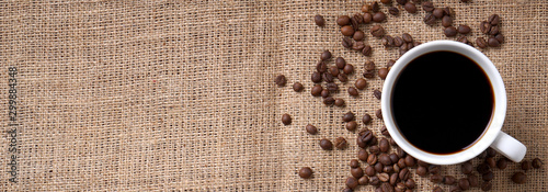 cup of coffee and coffee beans on jute