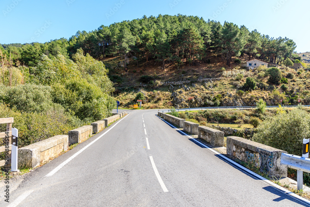 Highway with First fall colors in the mountains of Madrid, Spain Highway with First fall colors in the mountains of Madrid, Spain