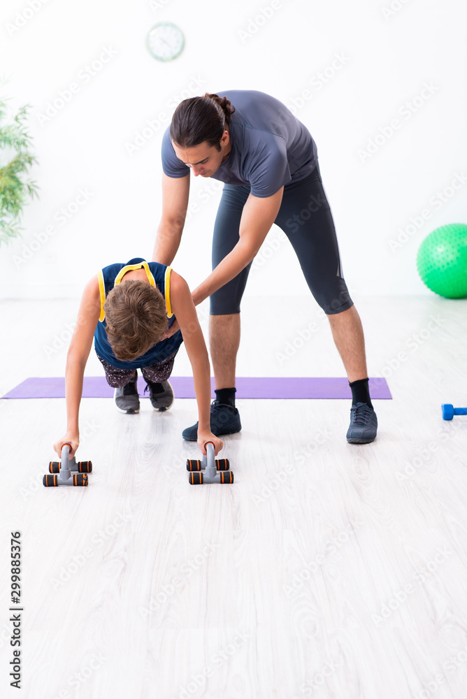 Young father and his son doing exercises Young father and his son doing exercises