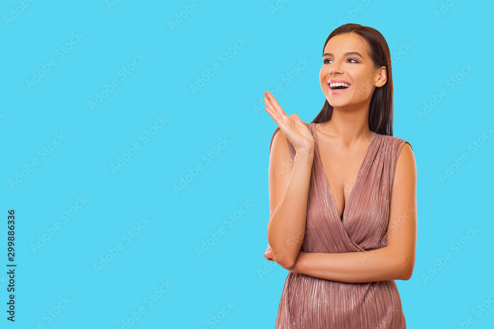 Beautiful Girl on a color background. Joyful young brunette woman on a blue background. Beautiful Girl on a color background. Joyful young brunette woman on a blue background.