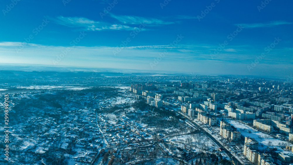 Top view of city in winter at sunset on sky background. Aerial drone photography concept. Kishinev, Republic of Moldova.