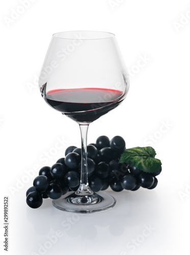 glass of red wine with grapes