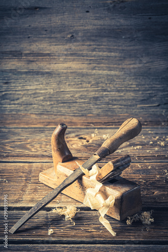 Closeup of rustic chisel and planer in a carpentry workshop photo