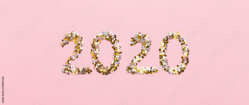 2020 big letters of gold confetti on pink background 2020 big letters of gold confetti on pink background