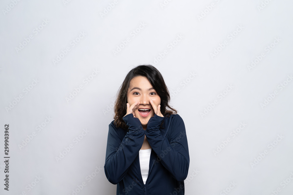 Portrait of a healthy woman make whisper gesture isolated over white background Portrait of a healthy woman make whisper gesture isolated over white background