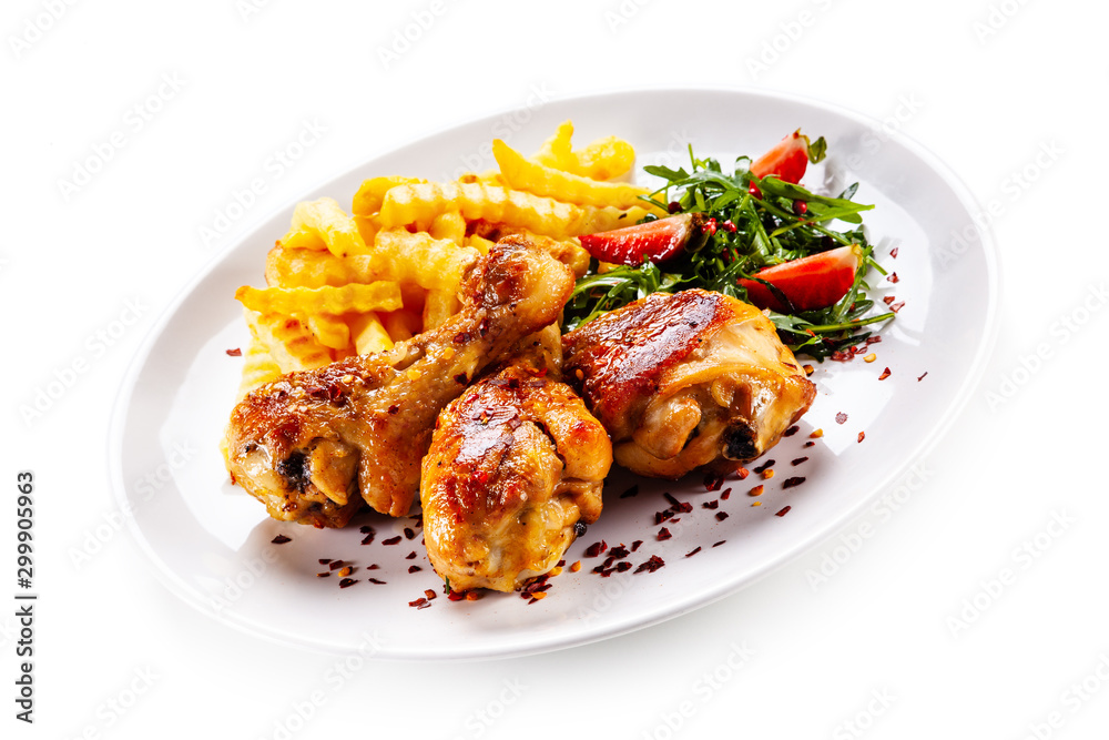 Grilled chicken drumsticks with french fries and vegetables Grilled chicken drumsticks with french fries and vegetables