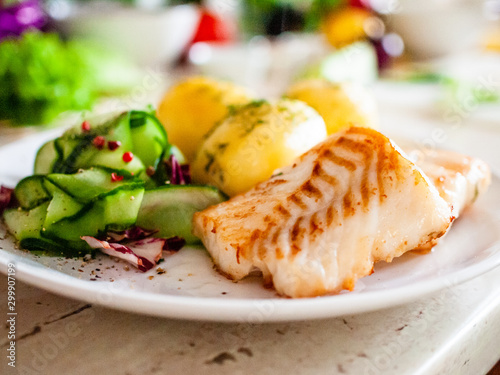 Photography Fried fish with potatoes on white plate