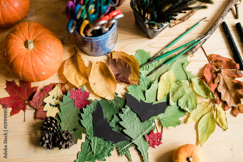 Autumn background with dry colorful leaves, pumpkins, pinecones, paintbrushes