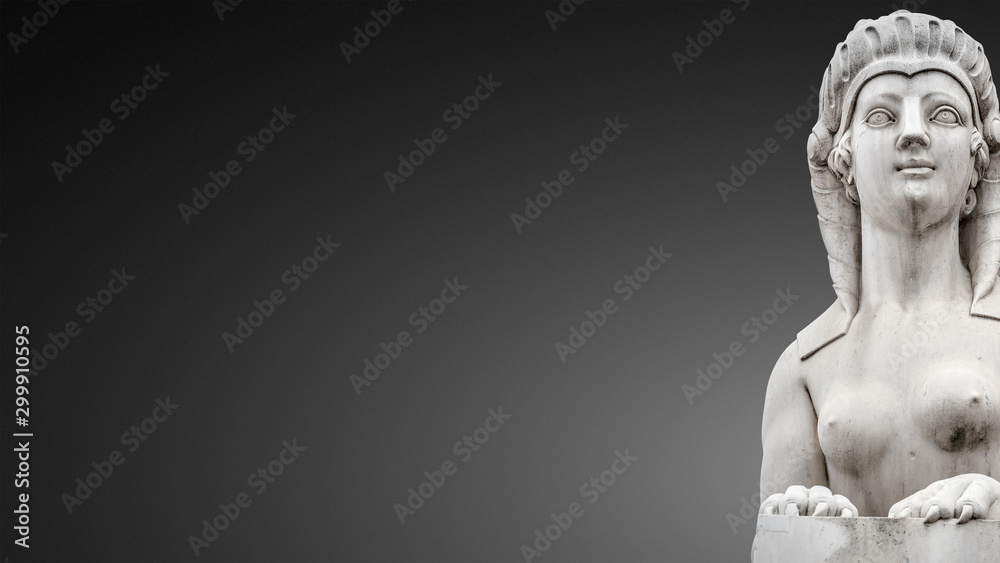 Statue of beautiful Egyptian sphinx, a fusion of a lion and a woman in downtown of Potsdam isolated at smooth even grey background, Germany, portrait, details, paste space