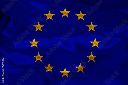 close-up photo of beautiful colored stylized European Union flag, symbol of united Europe on textured fabric, concept of tourism, emigration, economy and politics, close-up