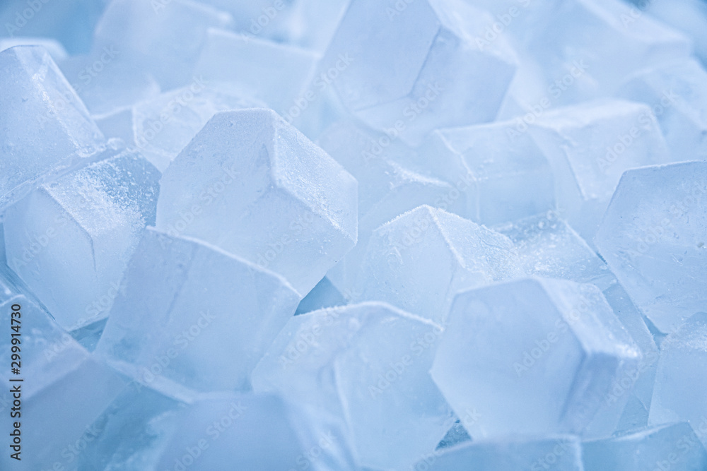 Macro shot of ice cubes from clear water that melt in slow motion on a white background. Concept: pure mountain spring water, ice, cocktails, fresh and frozen foods. Macro shot of ice cubes from clear water that melt in slow motion on a white background. Concept: pure mountain spring water, ice, cocktails, fresh and frozen foods.