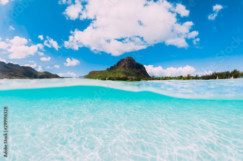 Tropical ocean with sand and Le Morne mountain in Mauritius.
