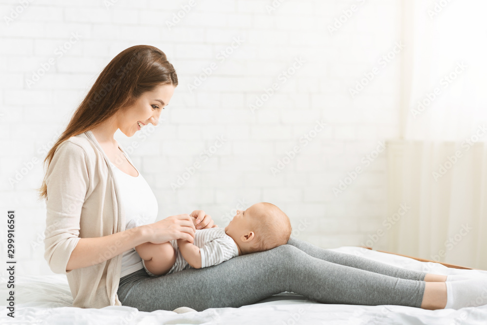 Millennial mom spending time with her newborn baby at home. Millennial mom spending time with her newborn baby at home.