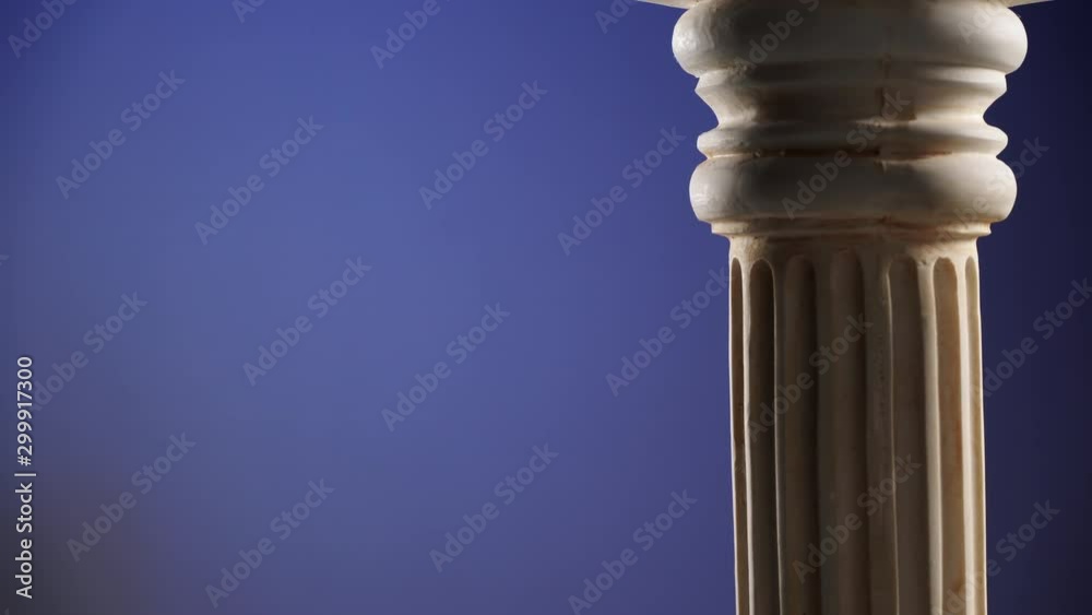 Single ancient greek column rotating slowly on dark blue background, copy space text area Single ancient greek column rotating slowly on dark blue background, copy space text area