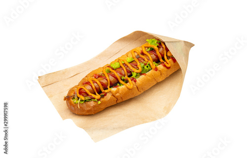 Fototapeta Naklejka Na Ścianę i Meble -  Hot dog with salad and cucumbers with tomato ketchup and mustard on white background. Tasty and beautiful fast food on a light back.