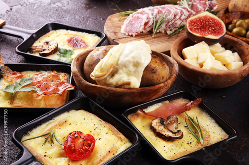 Canvas Print Delicious traditional Swiss melted raclette cheese on diced boiled or baked potato