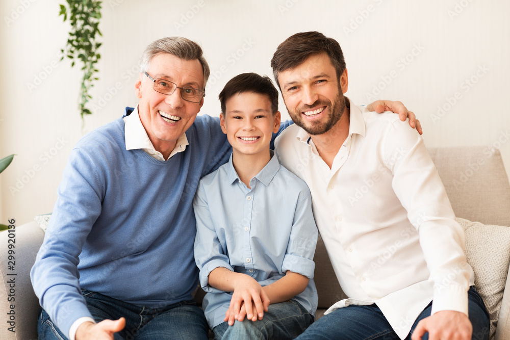Grandfather With Son And Grandson Sitting On Couch At Home Grandfather With Son And Grandson Sitting On Couch At Home