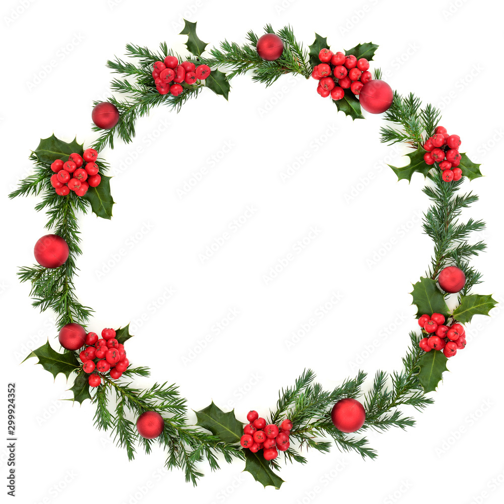 Christmas winter & new year juniper fir wreath with red baubles & loose red holly berries on white background with copy space. Traditional symbol for the festive season. Flat lay. Christmas winter & new year juniper fir wreath with red baubles & loose red holly berries on white background with copy space. Traditional symbol for the festive season. Flat lay.