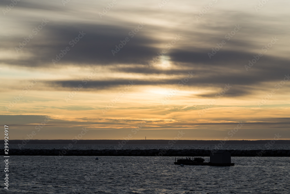 Naklejka premium Boathouse and the Long Point Light Station in the distance panoramic view from MacMillan Wharf.