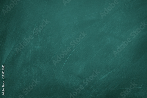Texture of chalk on green blackboard / chalkboard background, can be use as concept for school education, dark wall backdrop , design template. photo