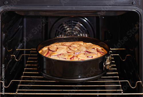 Freshly made homemade apple pie in the domestic oven. Shallow focus.