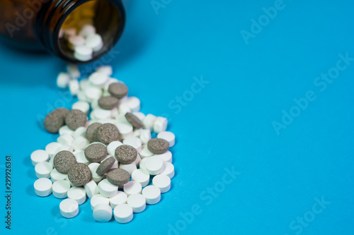 pills and bottle on blue background