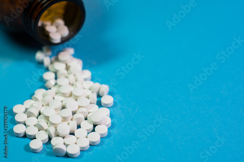 pills and bottle on blue background