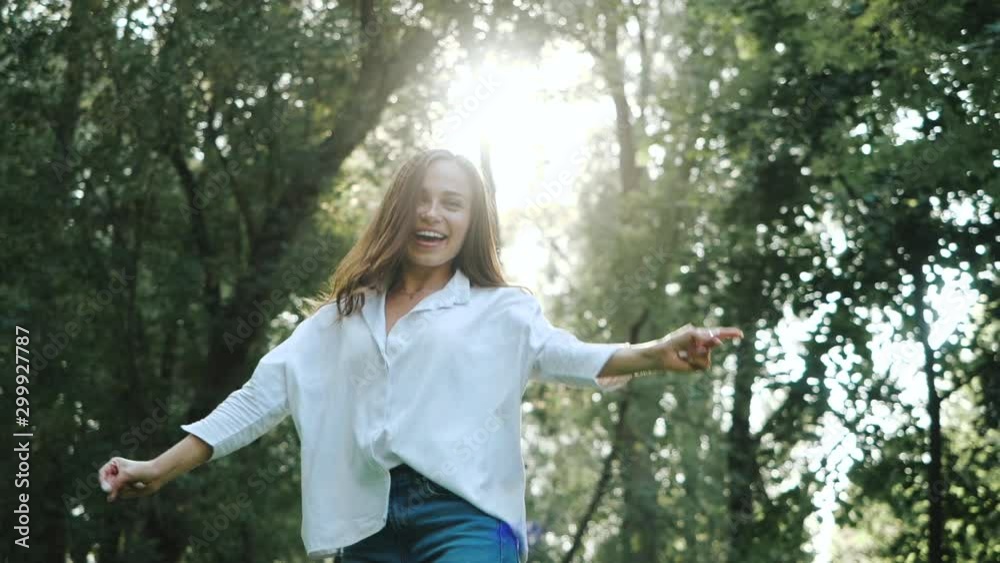 Close up of Young brunette girl smiling, spinning and dancing in Slow motion. Happy awesome Woman with hair blowing in wind looking at camera and smiling. Close up of Young brunette girl smiling, spinning and dancing in Slow motion. Happy awesome Woman with hair blowing in wind looking at camera and smiling.