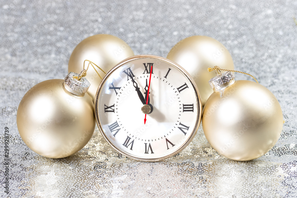 New Year card with Christmas balls and clock.