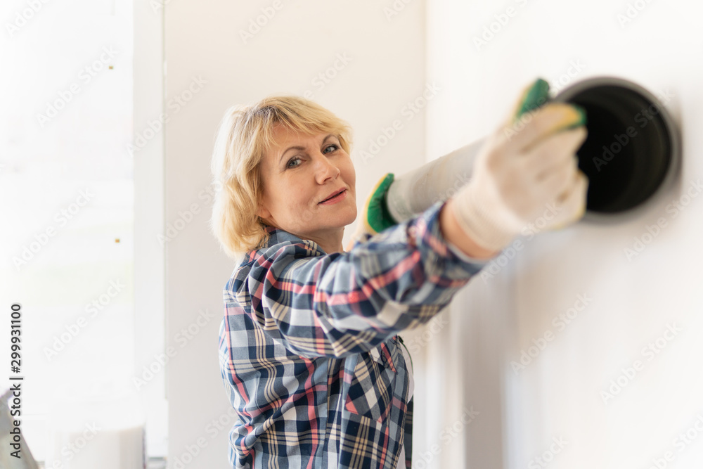 Woman Builder in the room of the house making repairs. Woman Builder in the room of the house making repairs.