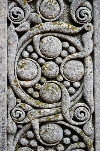 Intricately carved gravestone with celtic design circles and swirls