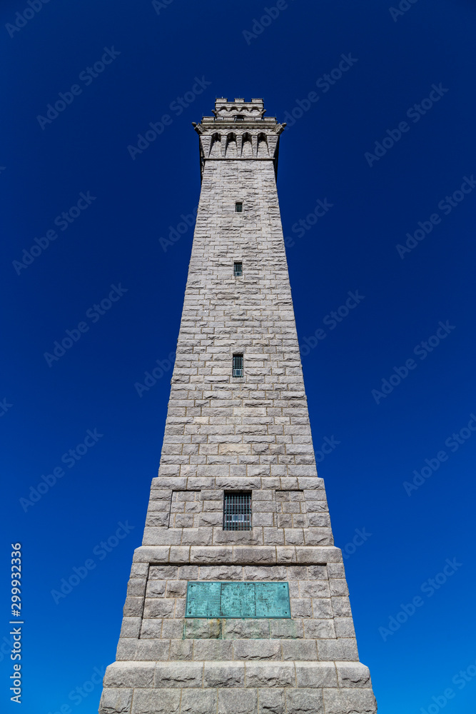 Pilgrim Monument Tower against blue sky background, Provincetown, Cape Cod, MA 
