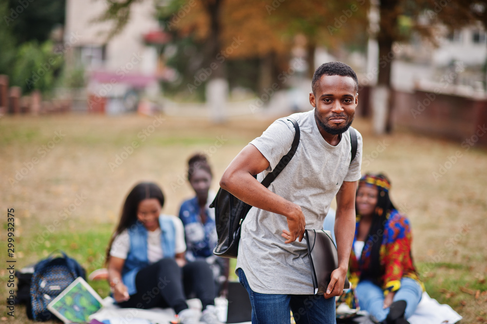 Group of five african college students spending time together on campus at university yard. Black afro friends studying. Education theme. Group of five african college students spending time together on campus at university yard. Black afro friends studying. Education theme.