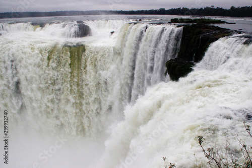 The main attraction of Brazil and Argentina is the famous Iguazu Falls among the lush green jungle. Huge streams of water fall to the ground. UNESCO World Heritage. Picture from paradise.