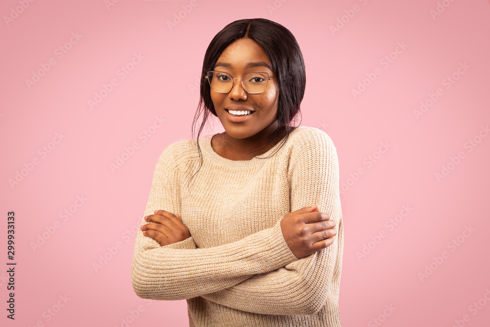 Afro Girl Smiling At Camera Crossing Hands Standing, Studio Shot Afro Girl Smiling At Camera Crossing Hands Standing, Studio Shot