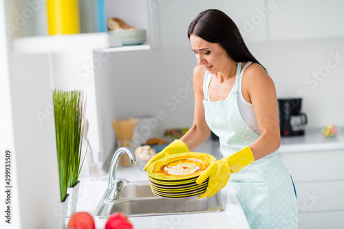 Profile side photo of surprised girl dont expect hard house work she need wash after fest dirty plates scream shout wear white singlet in kitchen house photo