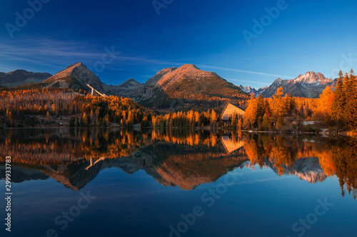 Autumn in Strbske lake in Slovakia during golden hour Tatra Mountains on the bakcground