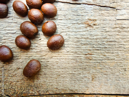 large grains of coffee on a wooden table. place for text