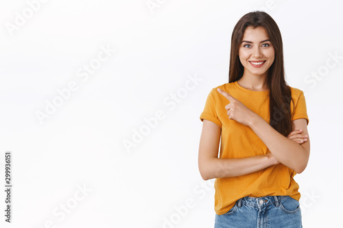 What are you waiting for, sign up now. Confident, determined and happy friendly-looking attractive woman in yellow t-shirt pointing upper left corner, advice buy black friday sale, smiling pleased
