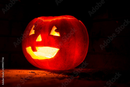 A carved pumpkin with light coming from inside