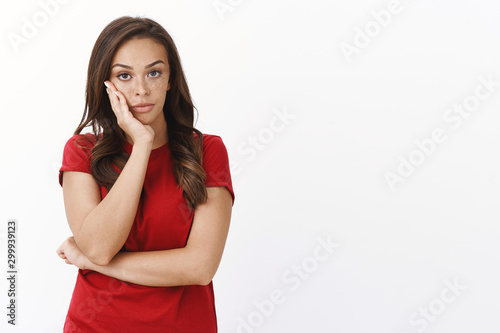 Slika na platnu Annoyed bothered intense young brunette woman in red t-shirt, furrow eyebrows, l
