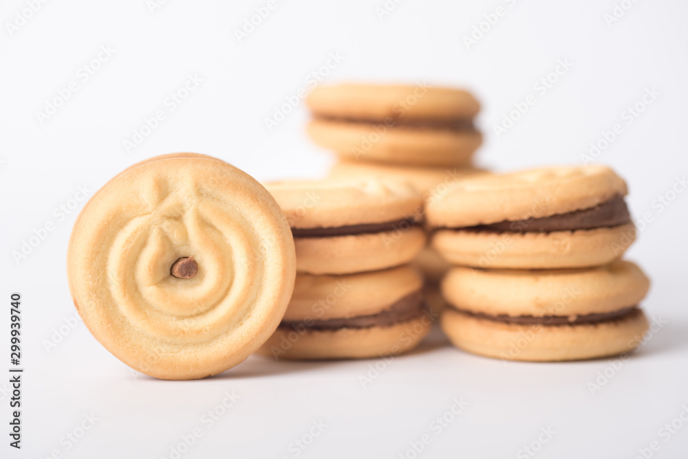 Cookies stuffed with coffee cream stacked on a white background. Cookies stuffed with coffee cream stacked on a white background.