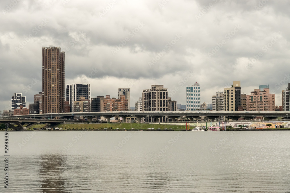 Fototapeta premium Taipei grey weather view from Dadaocheng Dock towards Sanchong district with buildings in a modern as well as functional architectural style