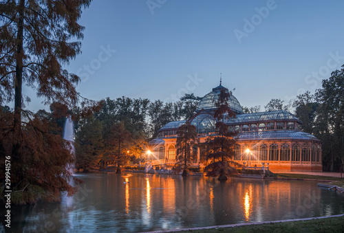 Blue hour view of Crystal Palace or Palacio de cristal in Retiro Park in Madrid, Spain. The Buen Retiro Park is one of the largest parks of the city of Madrid, Spain