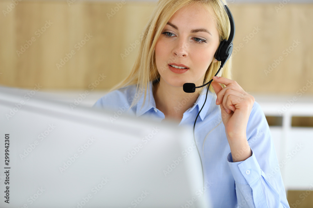 Call center. Blonde business woman sitting in headset at customer service office. Concept of telesales business or home office occupation Call center. Blonde business woman sitting in headset at customer service office. Concept of telesales business or home office occupation