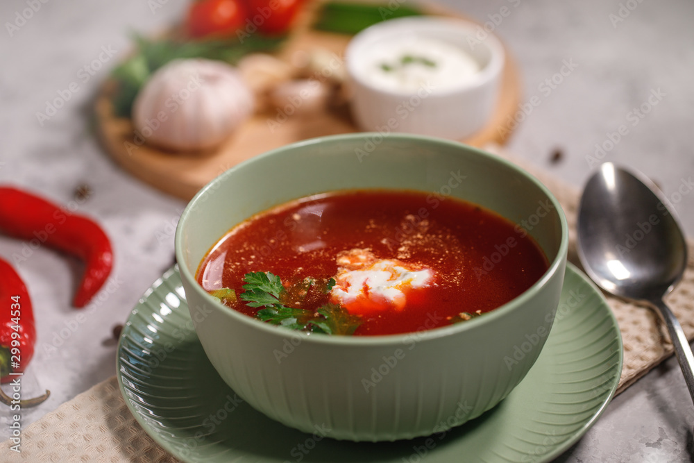 Beetroot soup with sour cream and herbs in a plate, close-up. Tasty and hearty dinner, borsch with vegetables. Still life Beetroot soup with sour cream and herbs in a plate, close-up. Tasty and hearty dinner, borsch with vegetables. Still life