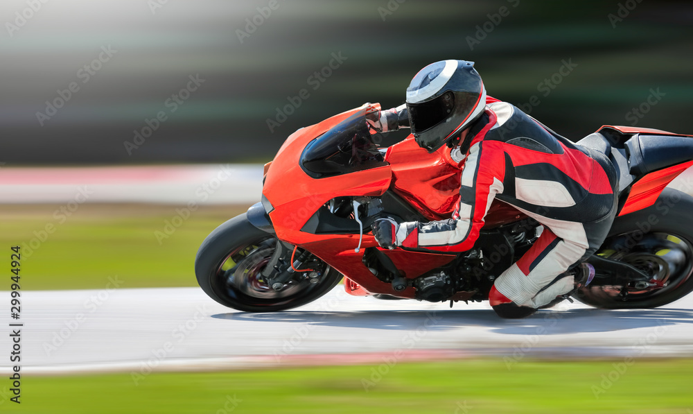 Motorcycle leaning into a fast corner on race track