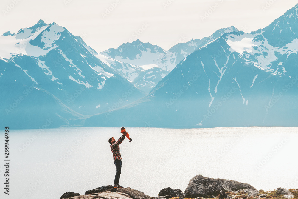 Father holding up baby hiking in mountains travel family adventure lifestyle vacations dad with kid outdoor journey in Norway - obrazy, fototapety, plakaty 